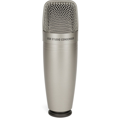 Samson C01U Pro USB microphone on a desk with a black stand, showing its cylindrical shape and professional audio equipment design.