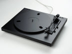 Pro-Ject Automat A1.2 turntable in black, featuring a sleek design with a tonearm and platter visible from a diagonal angle.