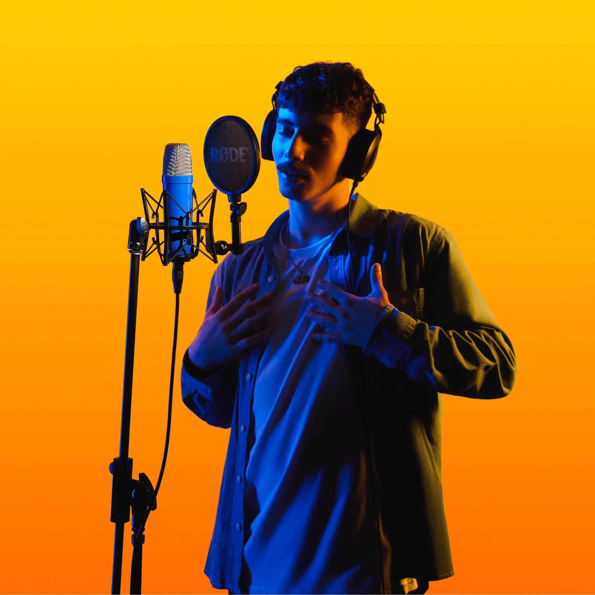 Rode NT1 Signature Series condenser microphone with a sleek design, shown in a professional studio setup.