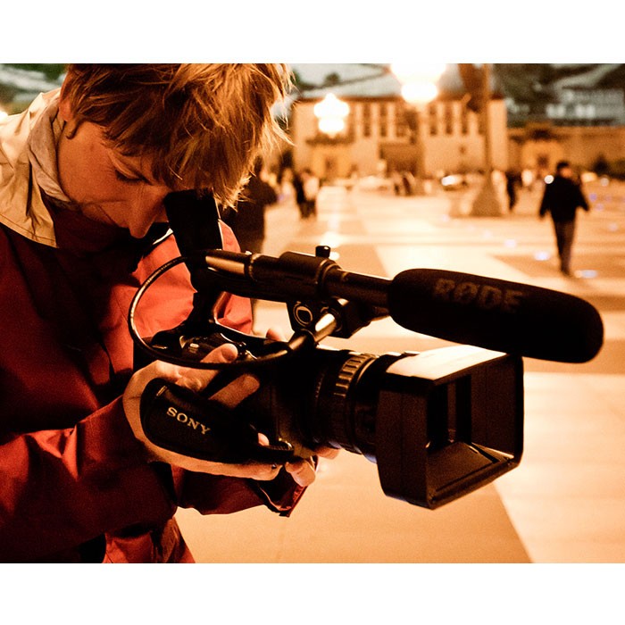 Rode NTG2 shotgun microphone mounted on a boom pole, professional audio recording equipment for film and video production.