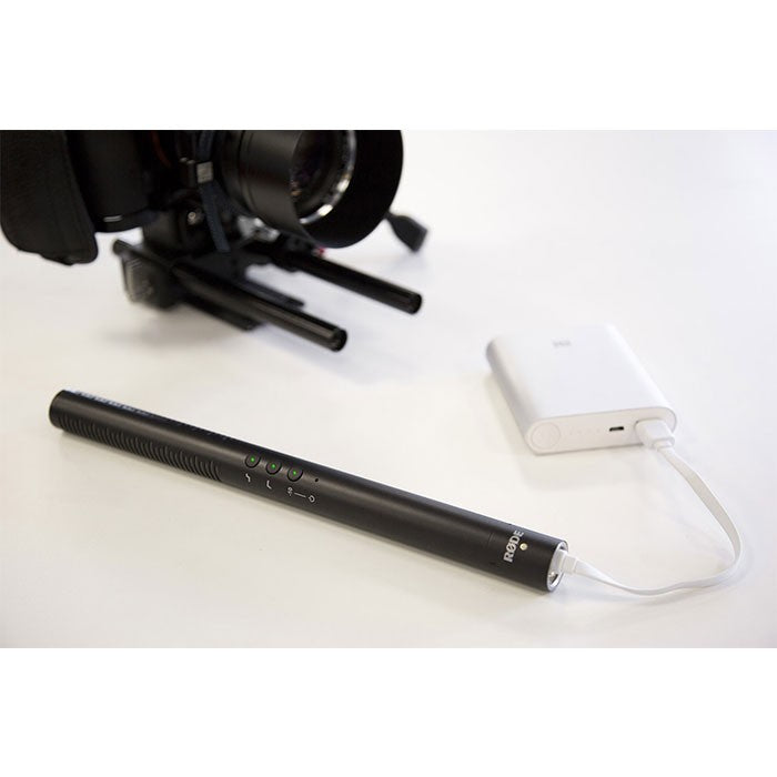 Rode NTG4+ shotgun microphone mounted on a boom pole, professional audio recording equipment for filmmaking or broadcasting.