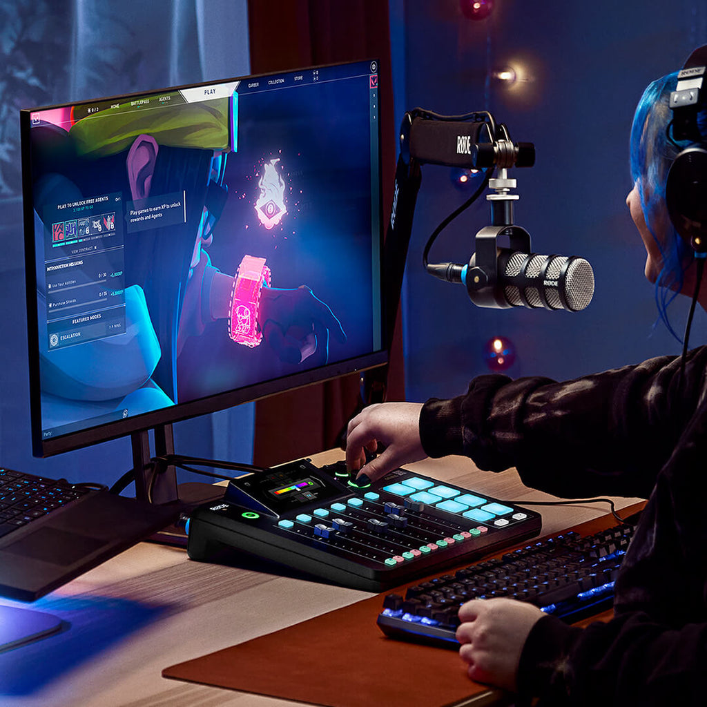 Rode RodeCaster Pro II digital mixer with customizable controls, shown in a gaming setup with colorful background lighting.