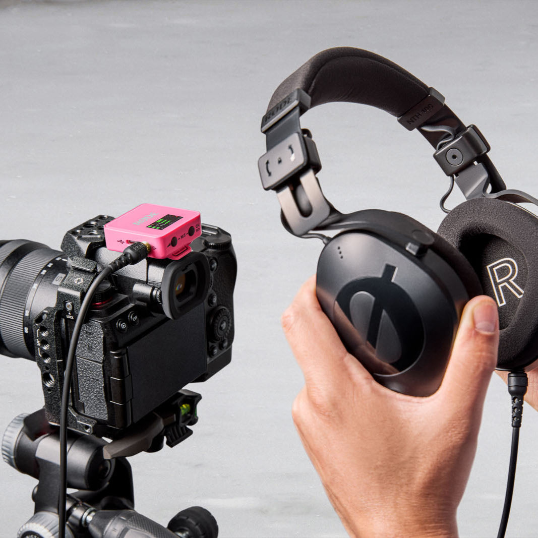 Rode Wireless GO 3 wireless microphone system with pink RGB monitor display, compact design for professional audio recording.