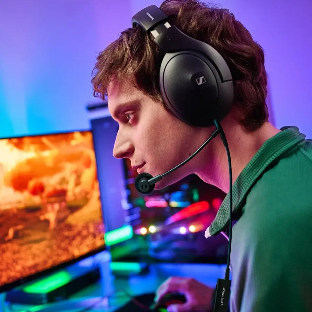 Gamer using the Sennheiser HD 500 BAM boom microphone at an RGB-lit desk
