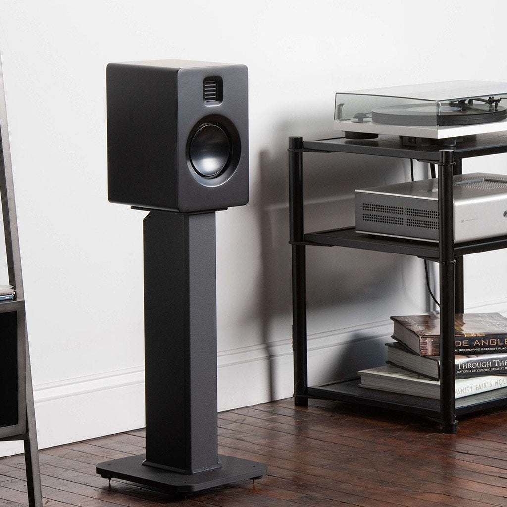 Kanto Audio SX Series 22-inch speaker stands supporting studio monitors with adjustable height and sturdy metal construction.