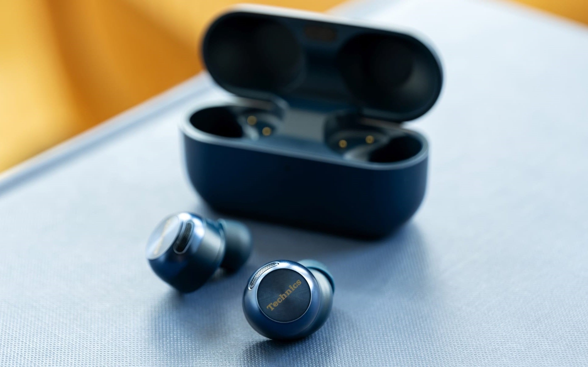 Technics EAH-AZ100 true wireless earbuds, in midnight blue, with charging case