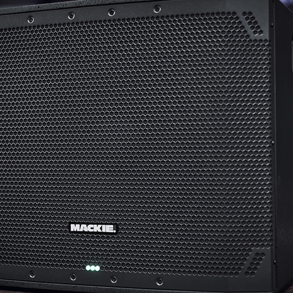 Close-up of the Mackie Thump18SV4 active subwoofer, showing its sturdy black speaker enclosure and control panel details.