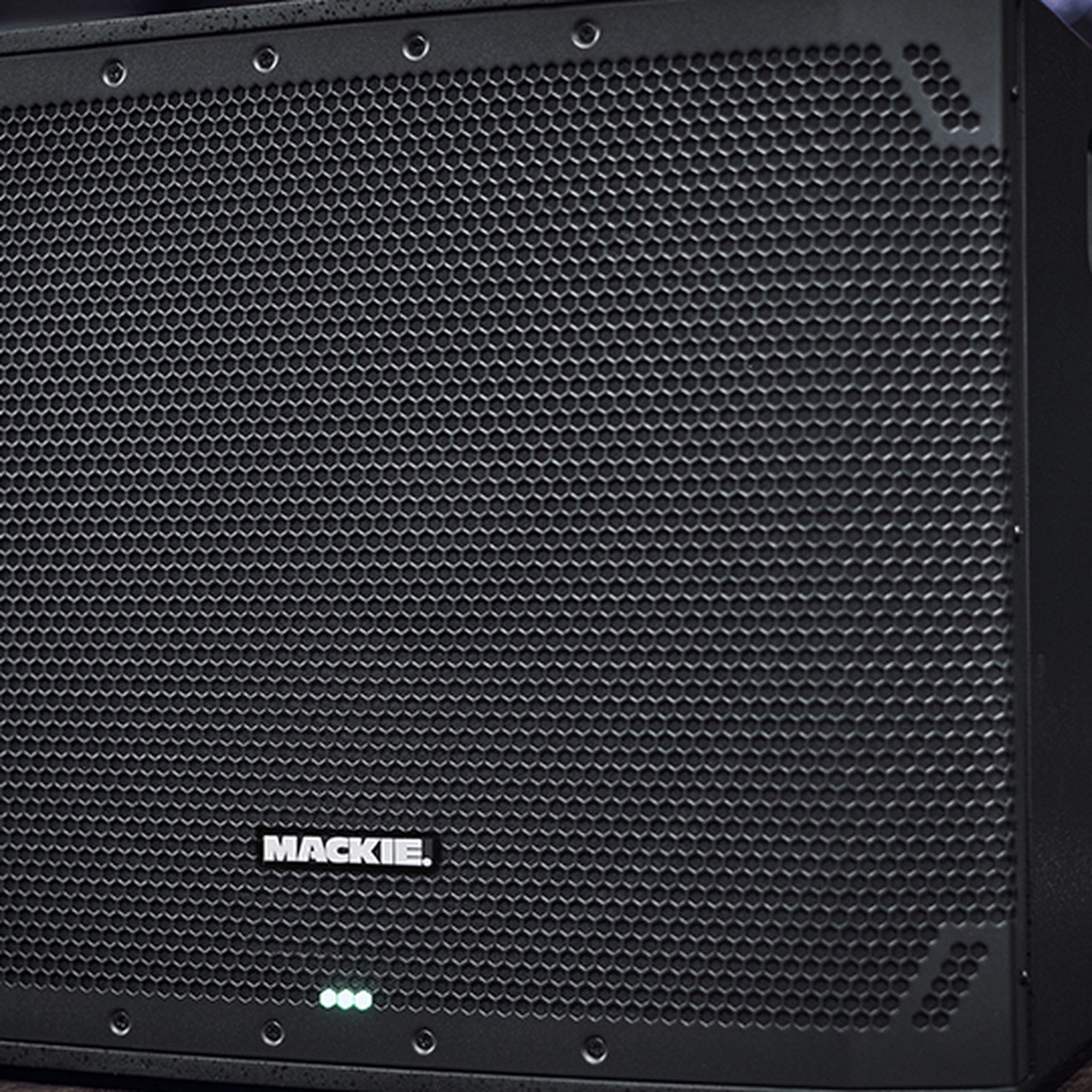 Close-up of the Mackie Thump18SV4 active subwoofer, showing its sturdy black speaker enclosure and control panel details.