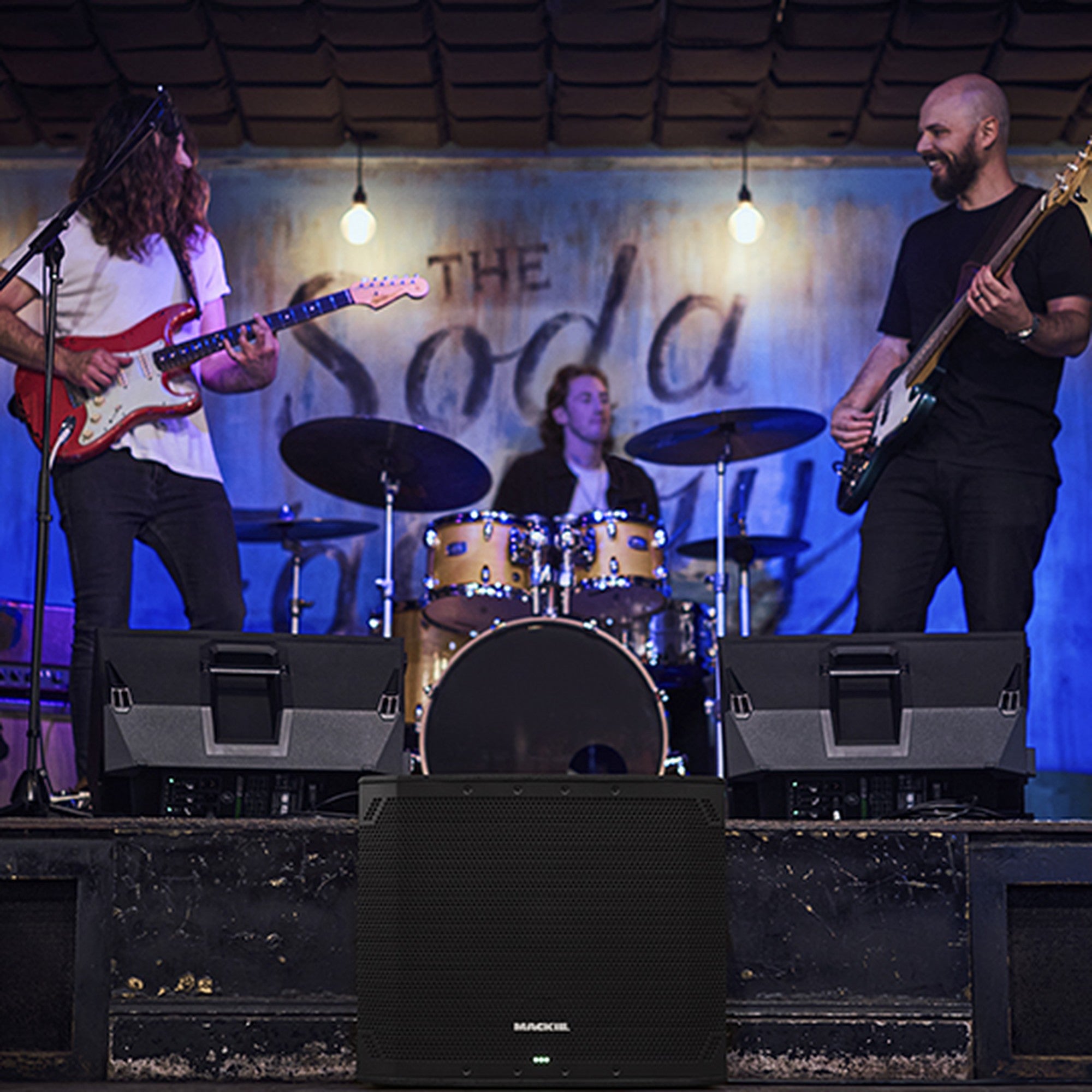 Mackie Thump18Sv4 active subwoofer on stage with stage lighting, showcasing its large speaker and durable design.