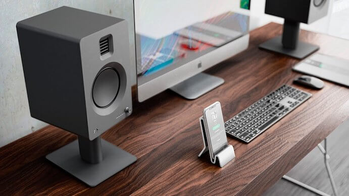 Kanto Audio TUK wireless speaker with sleek black design and compact size, featuring control buttons and connectivity ports.
