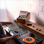 Reloop RP-7 DJ turntable with a sleek black platter, tonearm, and control knobs, designed for professional DJ setups.