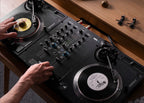 Reloop RP-7 DJ turntable with black platter and tonearm, featuring control knobs and pitch slider for professional mixing setup.