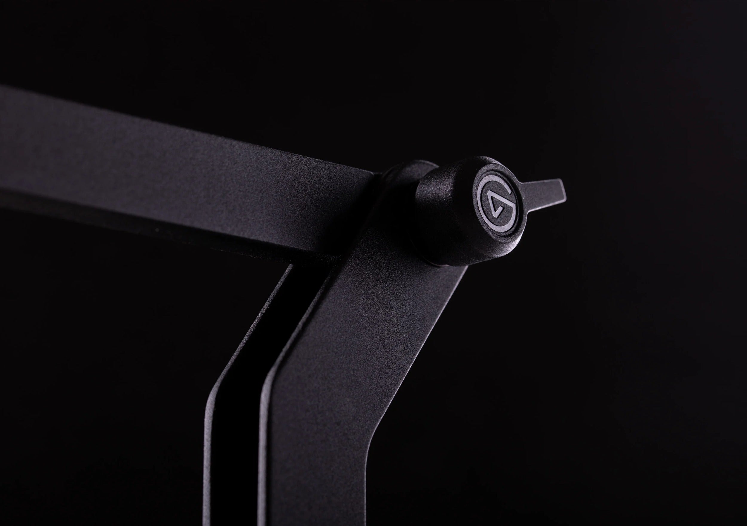 Elgato Wave Desk Stand holding a desktop microphone on a workspace with a computer and accessories.
