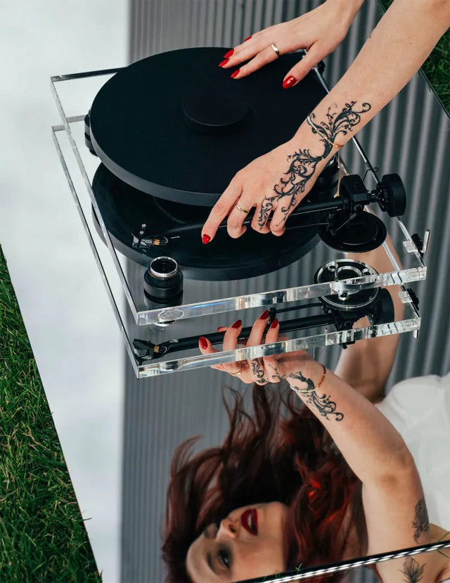 Pro-Ject XA B turntable with sleek wooden plinth and tonearm, set on a modern living room setup.