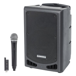 Samson XP208W portable PA system with two speakers and built-in mixer, set up for an outdoor event.